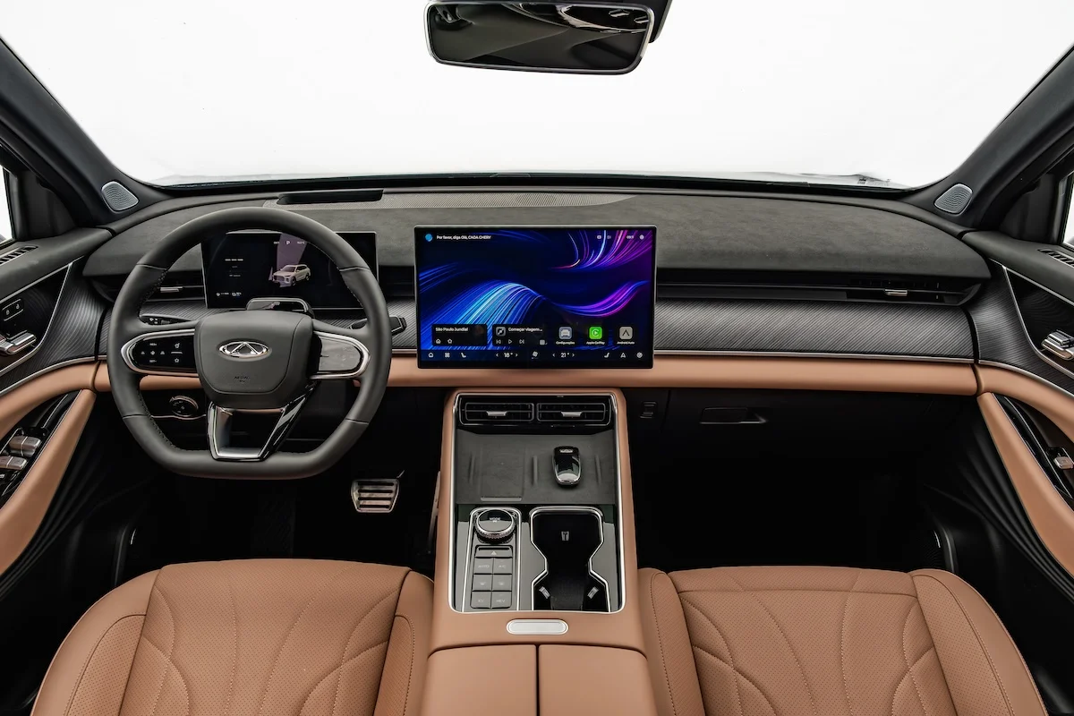 Interior do CAOA Chery Tiggo 9 exibindo volante multifuncional e painel tecnológico
